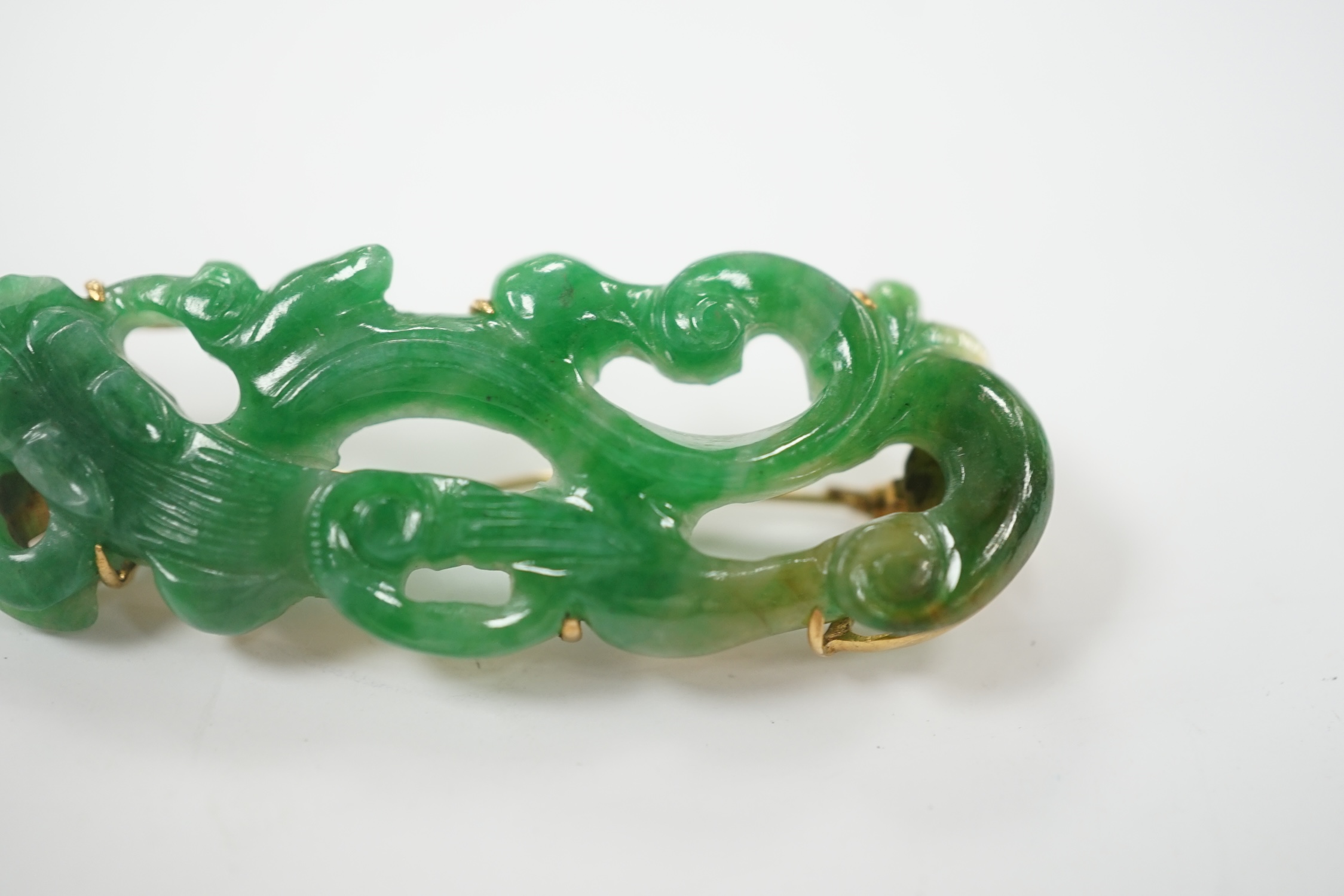 A Chinese 18k mounted carved jade brooch, 50mm, gross weight 9.1 grams.